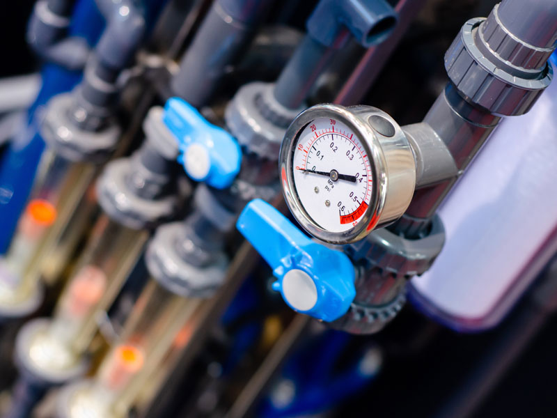 Close up of house heating system with many steel pipes, manometers and metal tubes.